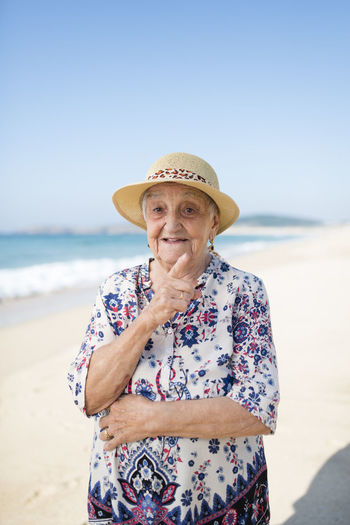 Portrait of senior woman standing on the beach