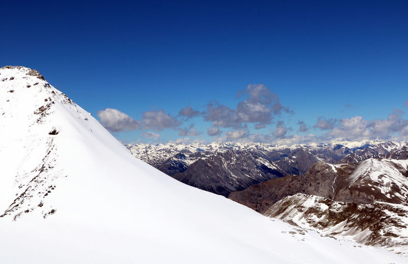 Snowcapped mountains against blue sky as seen from the livrio glacier, above stelvio stilfs pass, it