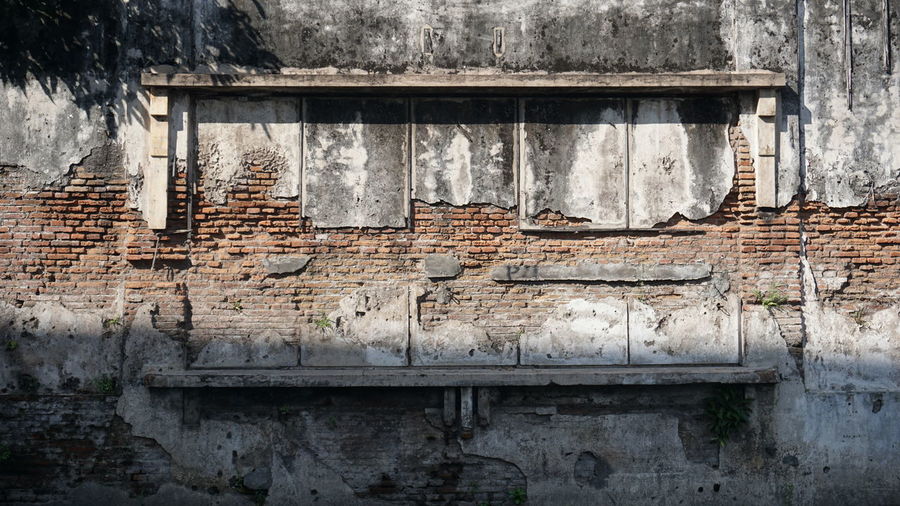 Low angle view of weathered wall of old building