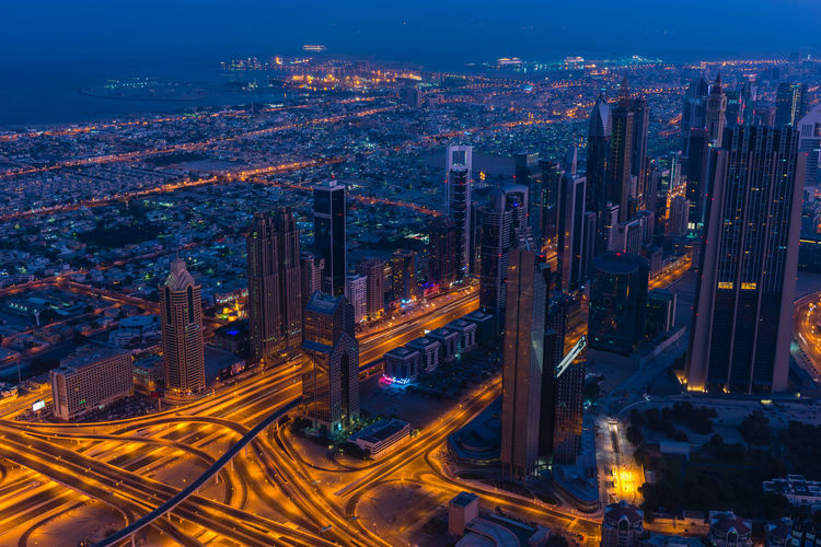Aerial view of illuminated buildings in city at night
