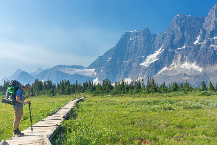 People walking on mountain against sky