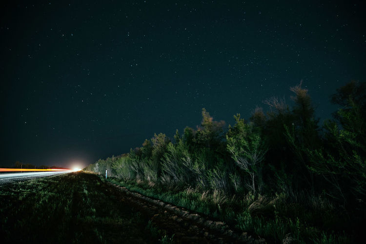 Illuminated car against sky at night