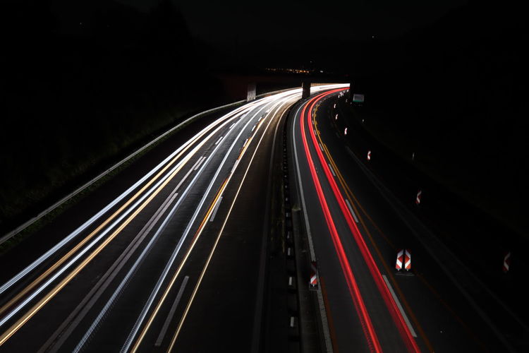 High angle view of light trails on highway at night
