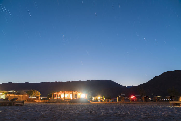 Illuminated straw huts at nuweiba by the beach, south sinai at night