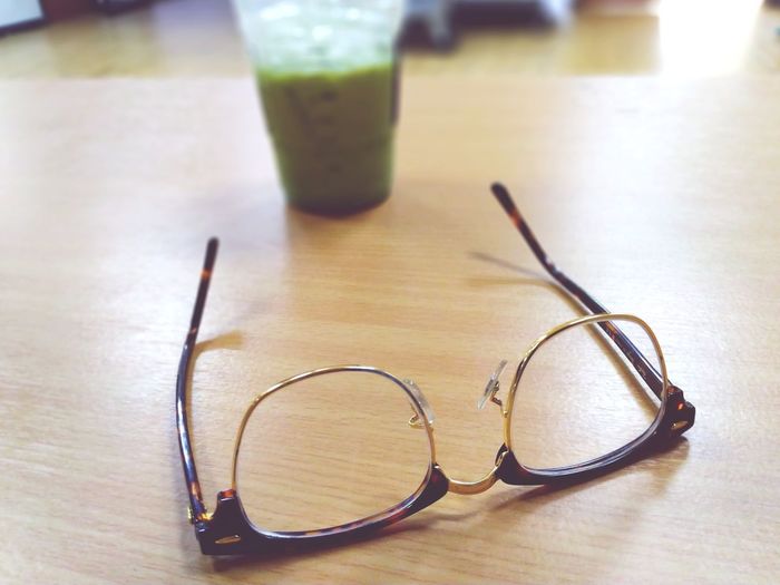 Close-up of sunglasses on glass table