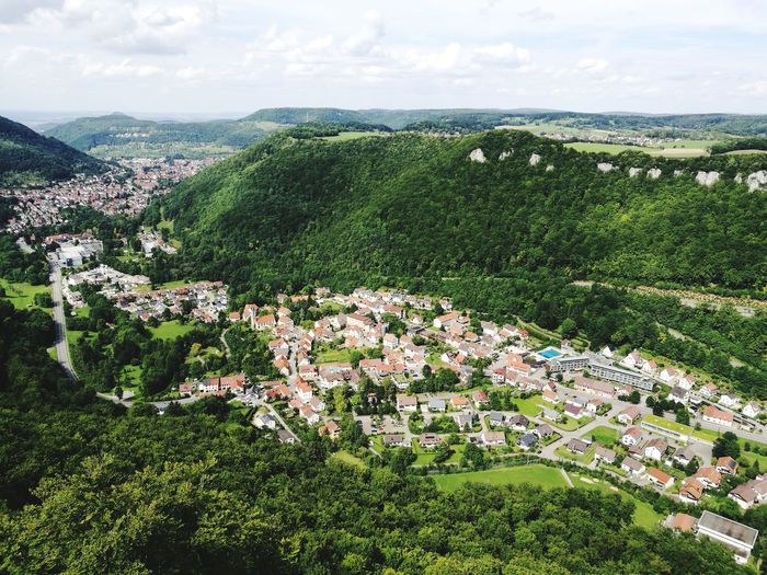 High angle view of trees and cityscape against sky