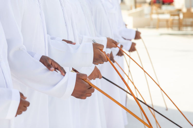 Traditional emirati al ayalah male dance, uae heritage, hands in frame