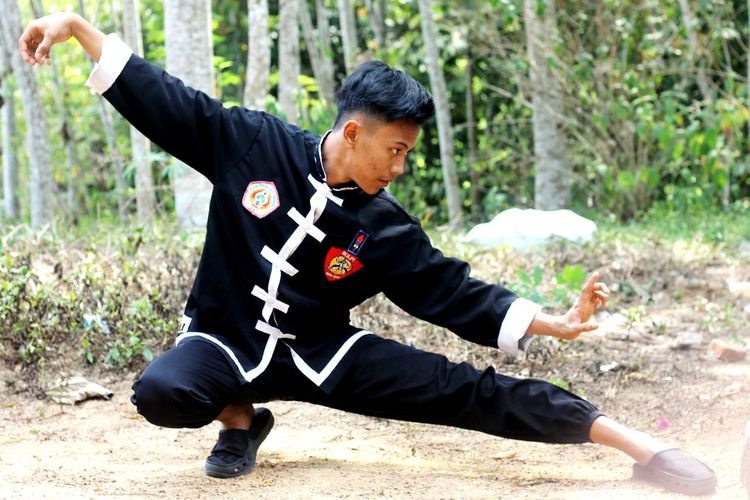 Full length of young man practicing martial arts