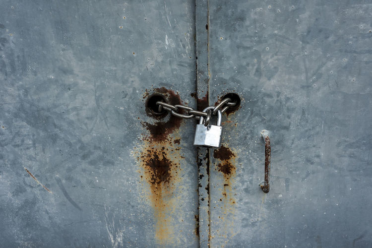 Close-up of padlock on metal door