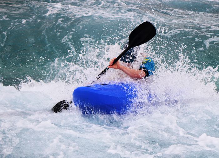 Man kayaking on river