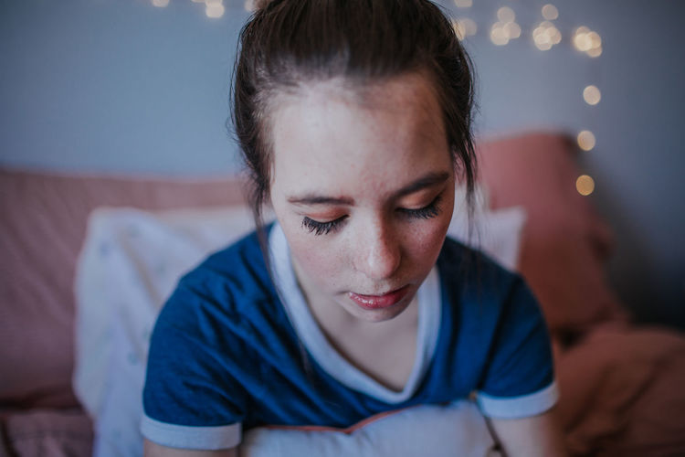 Portrait of woman relaxing on bed at home
