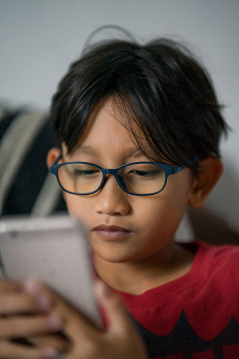 Close-up of boy using smartphone