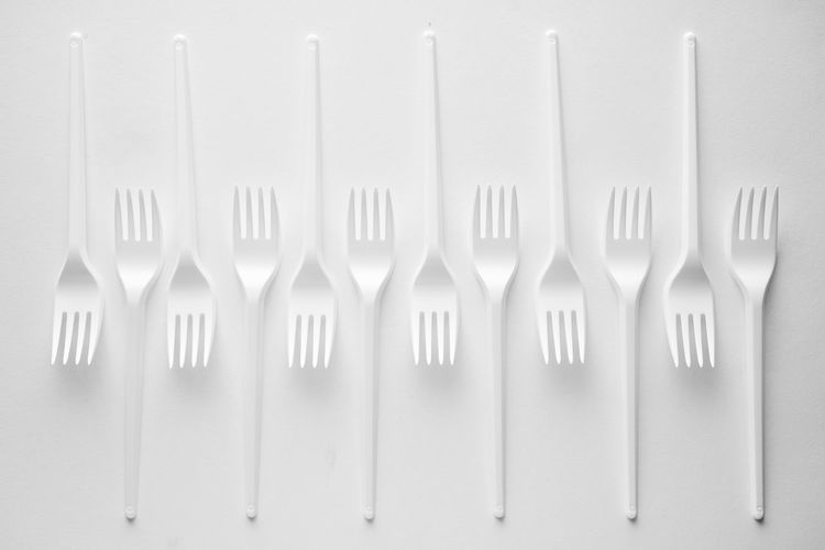 Row of objects on table against white background