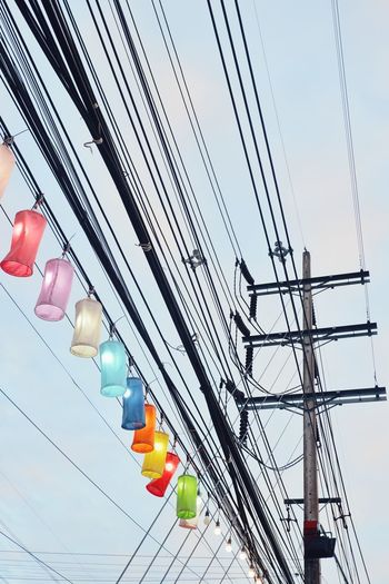 Low angle view of electricity pylon against sky