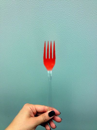 Woman hand holding plastic fork