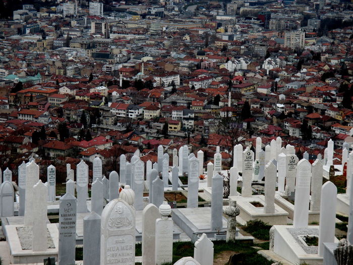 High angle view of cemetery by town