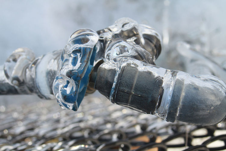 Close-up of frozen metallic pipe