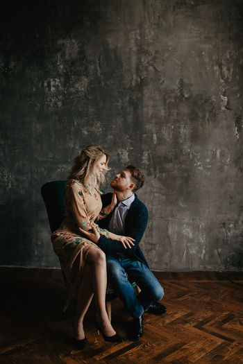 Beautiful couple, blonde girl and man with beard kissing, smiling