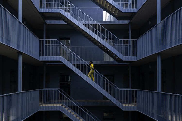 Woman walking on staircase of building