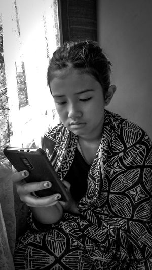 Young man using mobile phone at home