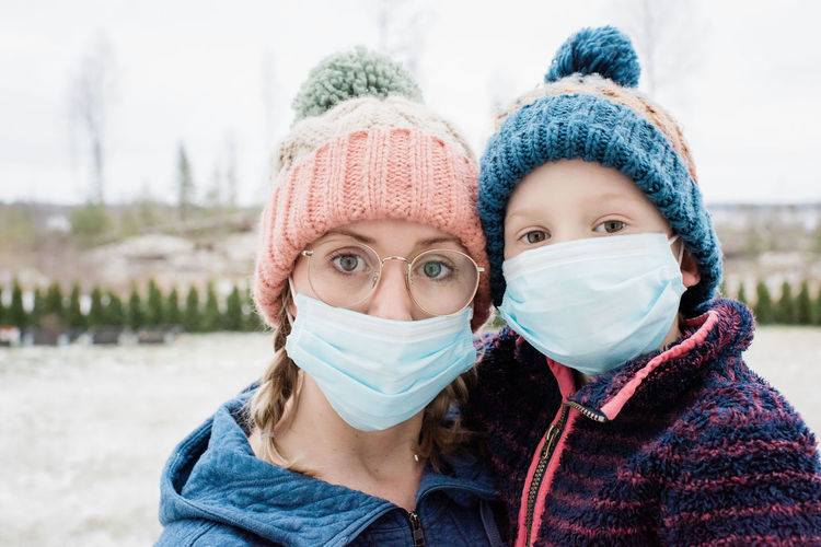 Mom and son wearing a face mask as protection from virus and flu