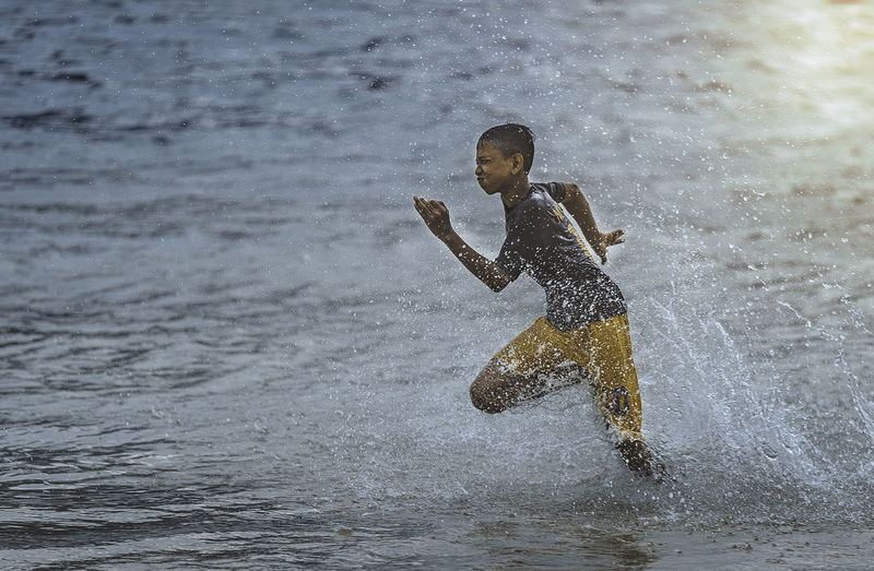 Boy running in sea