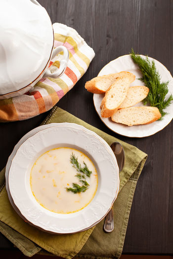 Creamy fish soup with salmon, potatoes, onions and carrots. finnish cuisine. top view