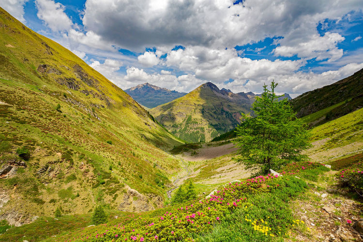 Scenic view of mountains against cloudy sky