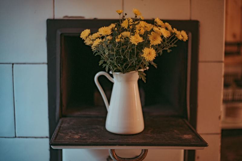Close-up of flower vase on table at home