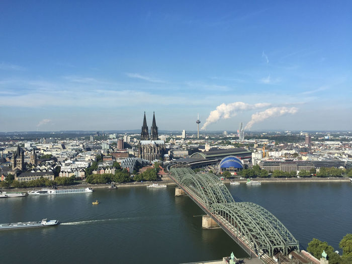 High angle view of hohenzollern bridge over rhine river by cityscape against sky