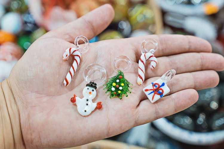 Close-up of hand holding christmas ornaments