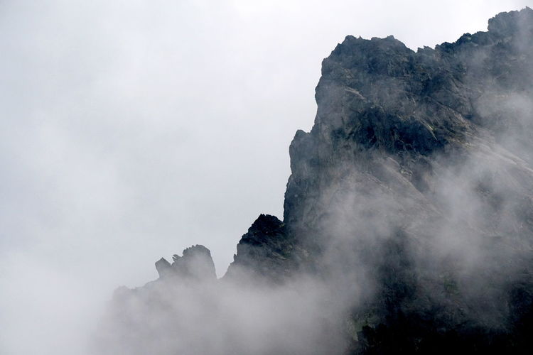 View of rock mountains amidst smoke
