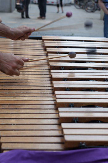 Cropped image of man playing xylophone on road