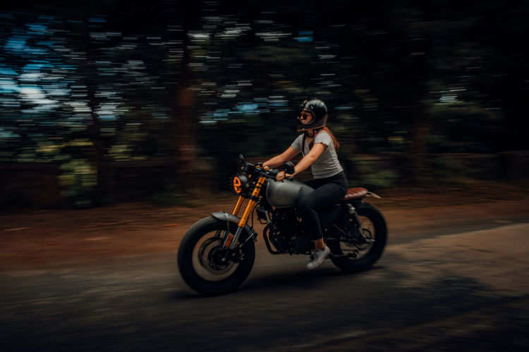 Woman riding motorcycle on road