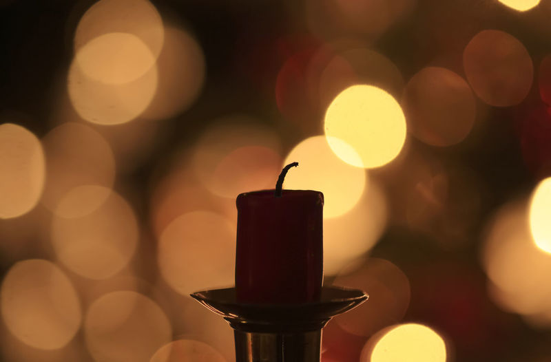 Close-up of illuminated candle against blurred background