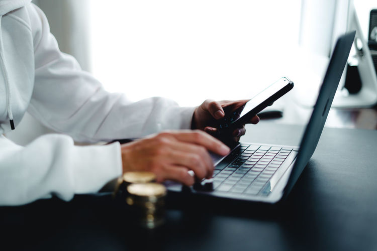 Midsection of doctor using laptop on table