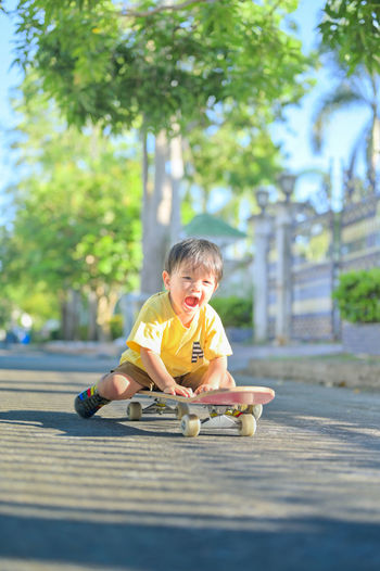 Portrait of boy wearing sunglasses against trees