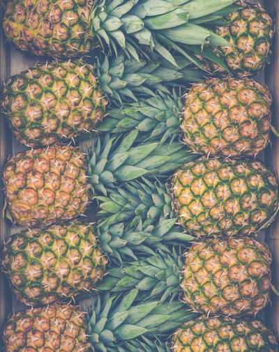 Retro style background texture of fresh pineapples at a market stall