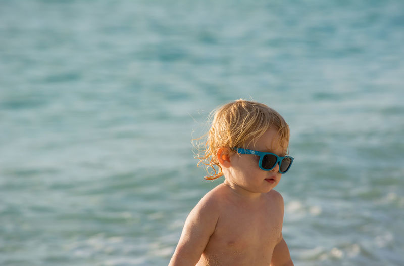 Cute boy standing at beach