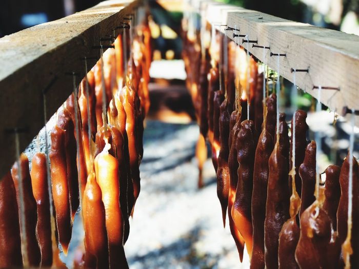 Close-up of meat hanging on barbecue grill