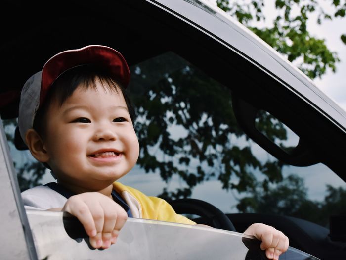 Portrait of happy boy in car