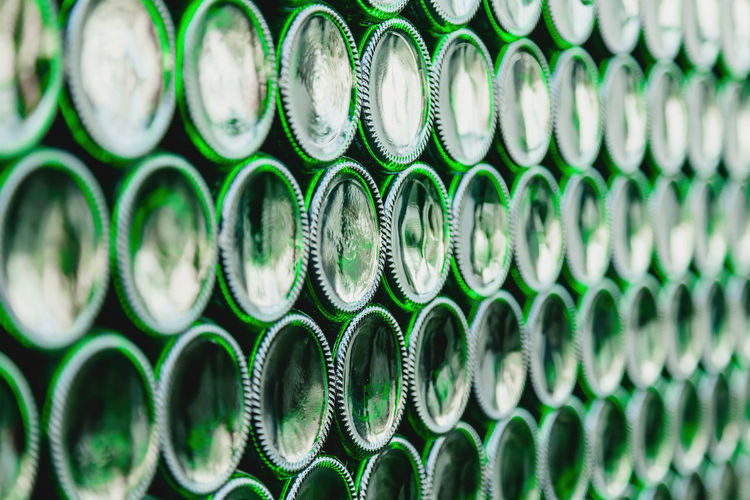 Glass bottles green. green glass bottles of beer. wall formed by green bottles. green bottles