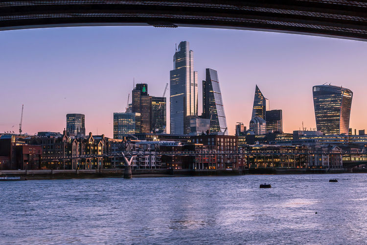Sunrise of london skyline and skyscrapers, with the river thames, framed by blackfriars bridge