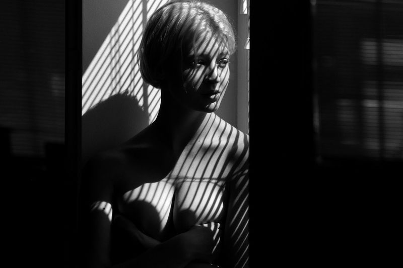 Close-up of woman standing in darkroom
