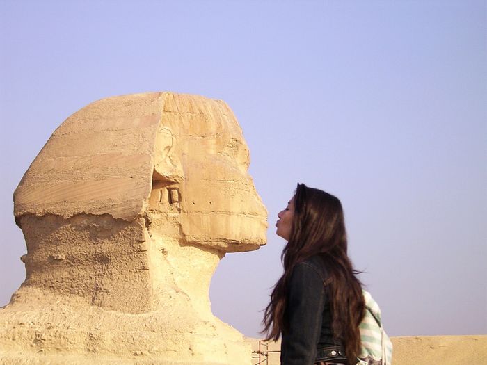 Optical illusion of woman kissing sphinx at great pyramid of giza