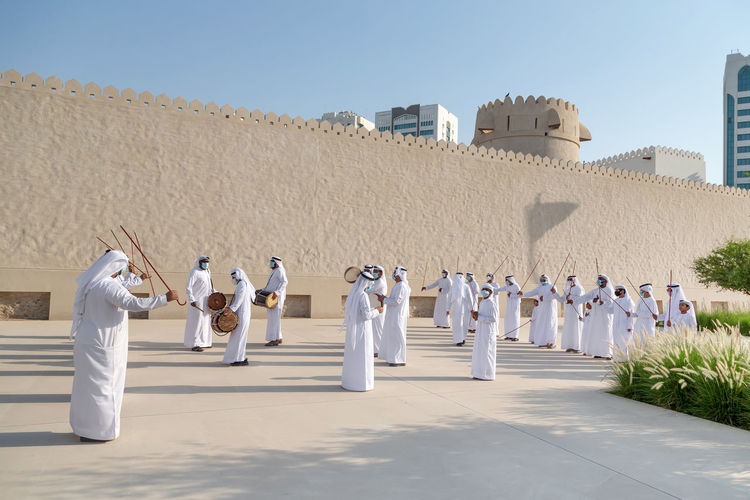 Traditional emirati male al ayalah dance at al hosn festival