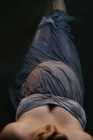 MIDSECTION OF WOMAN WEARING HAT