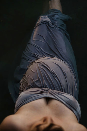 Midsection of woman against black background