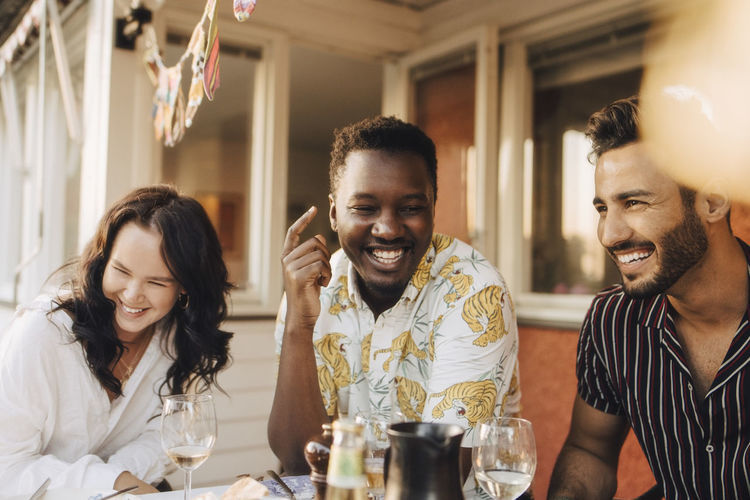 PORTRAIT OF A SMILING YOUNG MAN AND WOMAN AT HOME