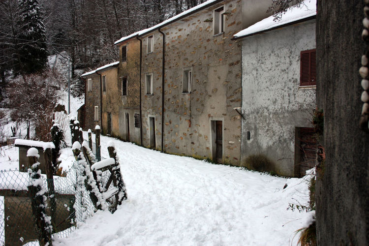 Abandoned village in white snowy mountain peak in reverse in the forest in tuscany